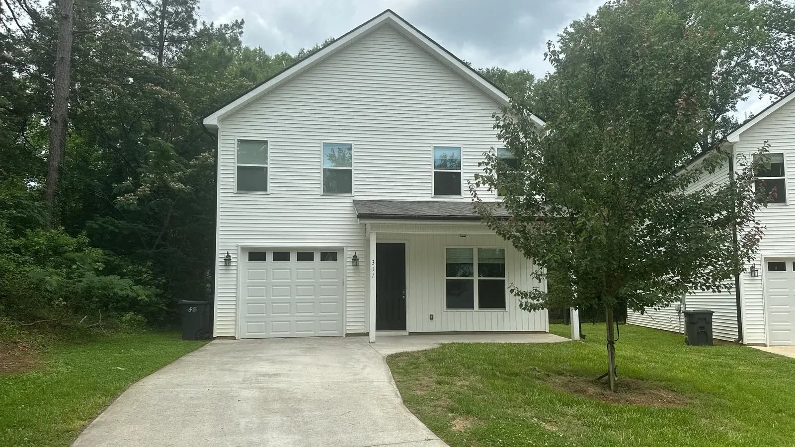 A four bedroom rental home with a one car garage and covered front porch at Village West in Travelers Rest, South Carolina