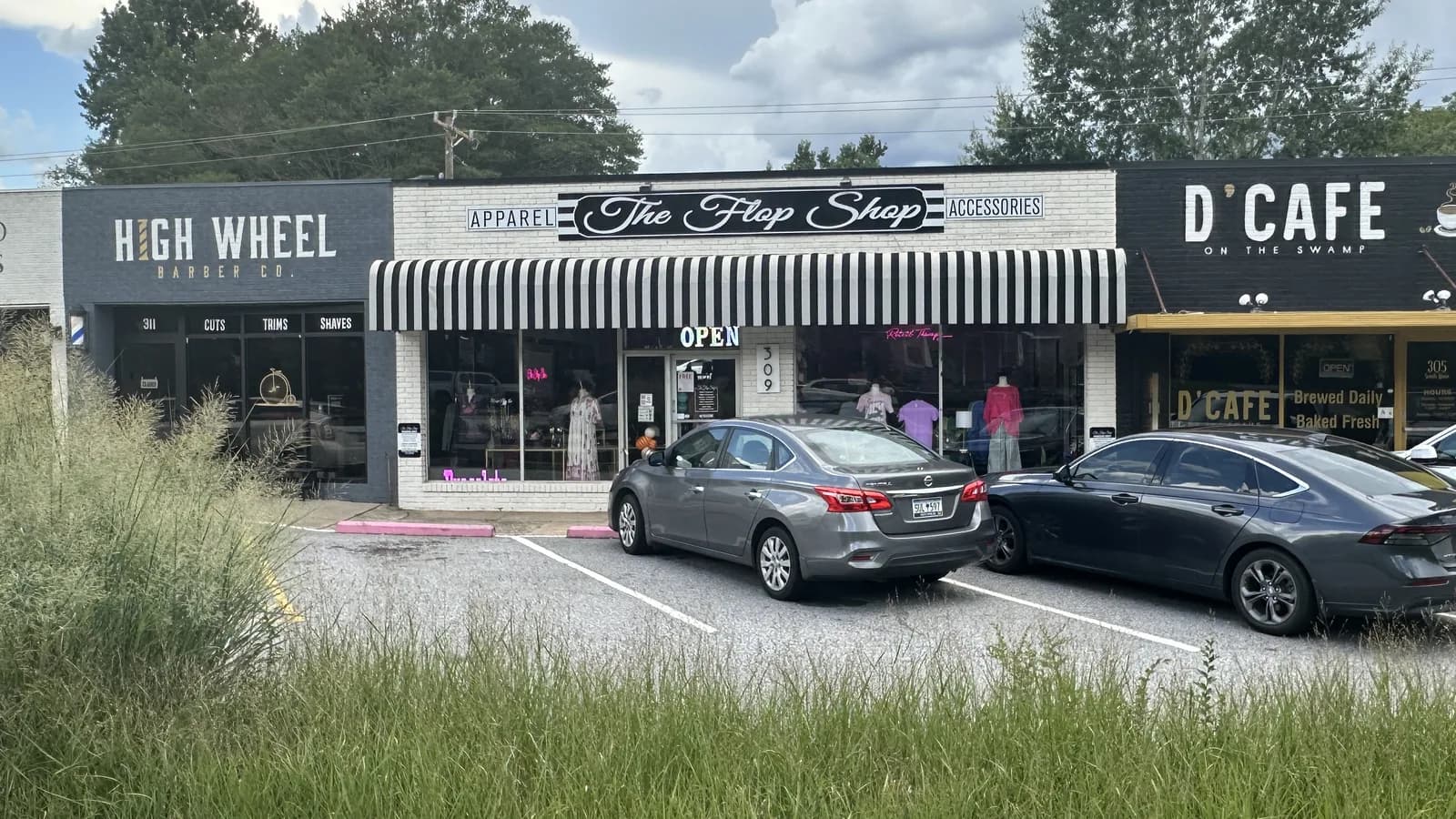 A row of independent shops on South Main Street in downtown Travelers Rest, South Carolina, including High Wheel Barber Co, The Flop Shop and D'Cafe