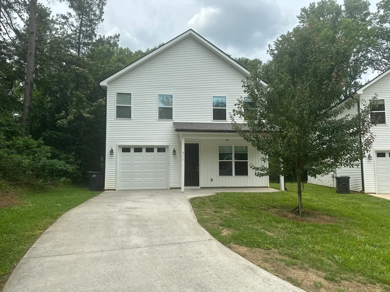 Exterior of the Ashton, a two story home with an attached garage and covered front porch in Travelers Rest, SC