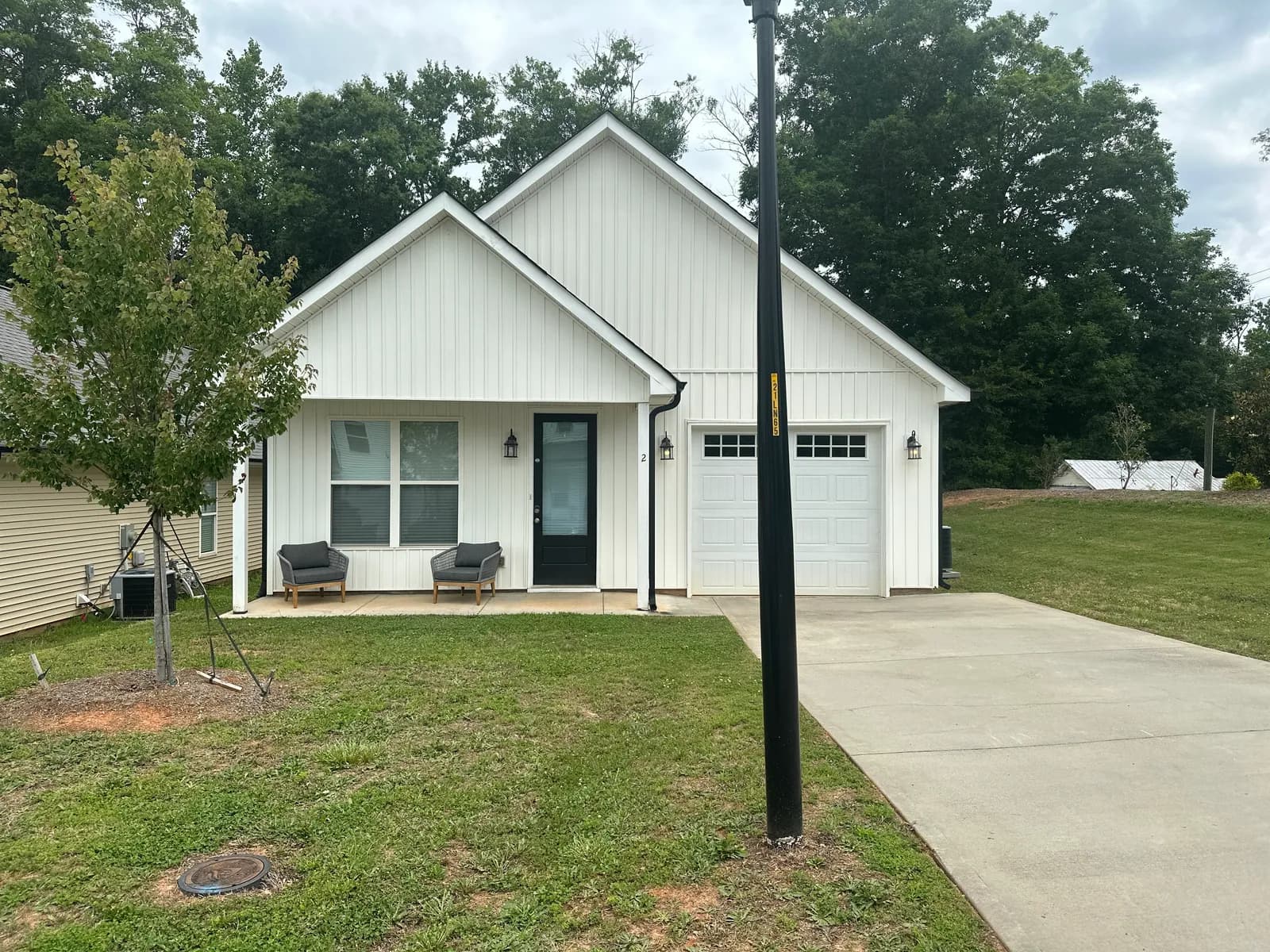 Covered front porch of 2 Solis Court on a quiet residential street in Travelers Rest