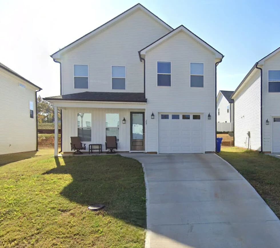 A two-story home with a covered front porch and garage in the Travelers Rest community